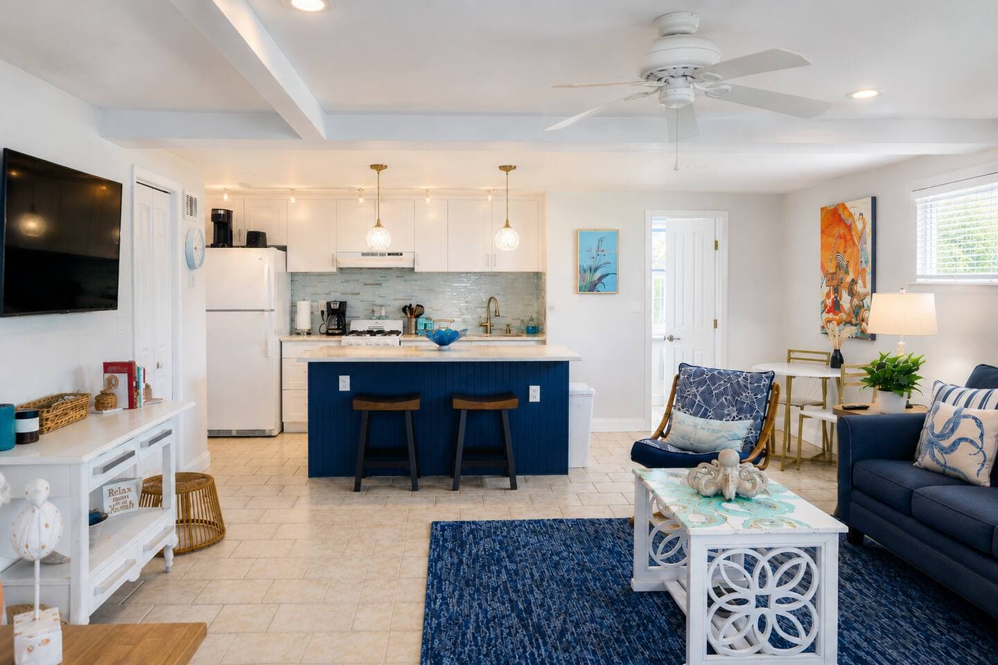 Bright coastal living space with stylish kitchen and breakfast bar