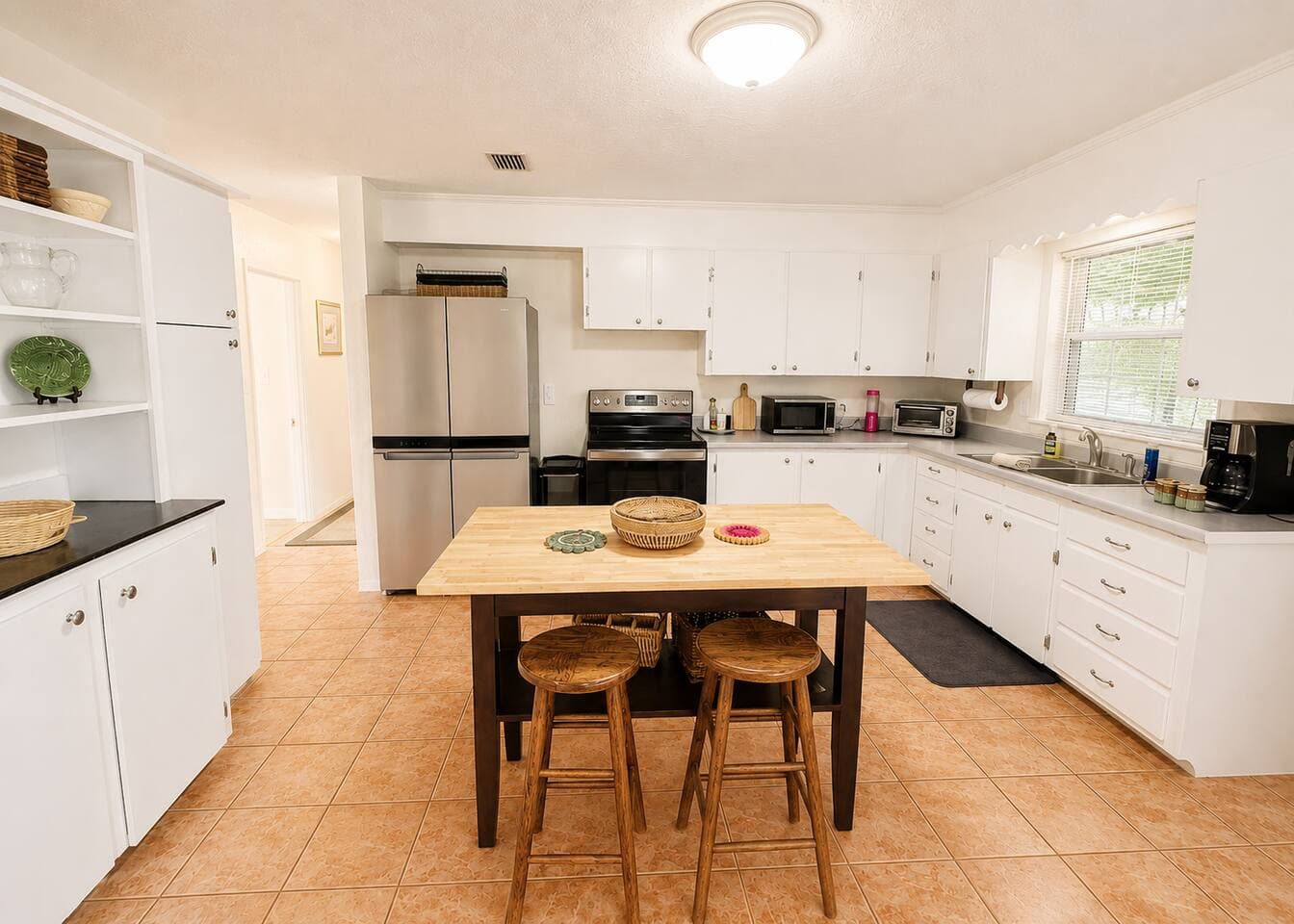 Bright, spacious kitchen with island seating and ample counter space