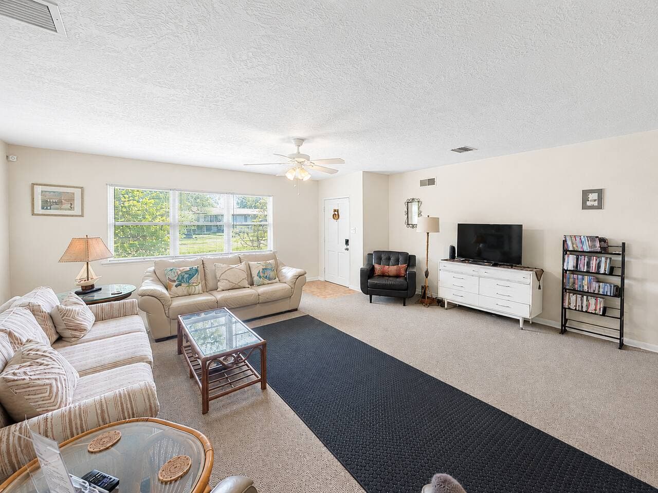 Bright, spacious living room with comfy seating and natural light