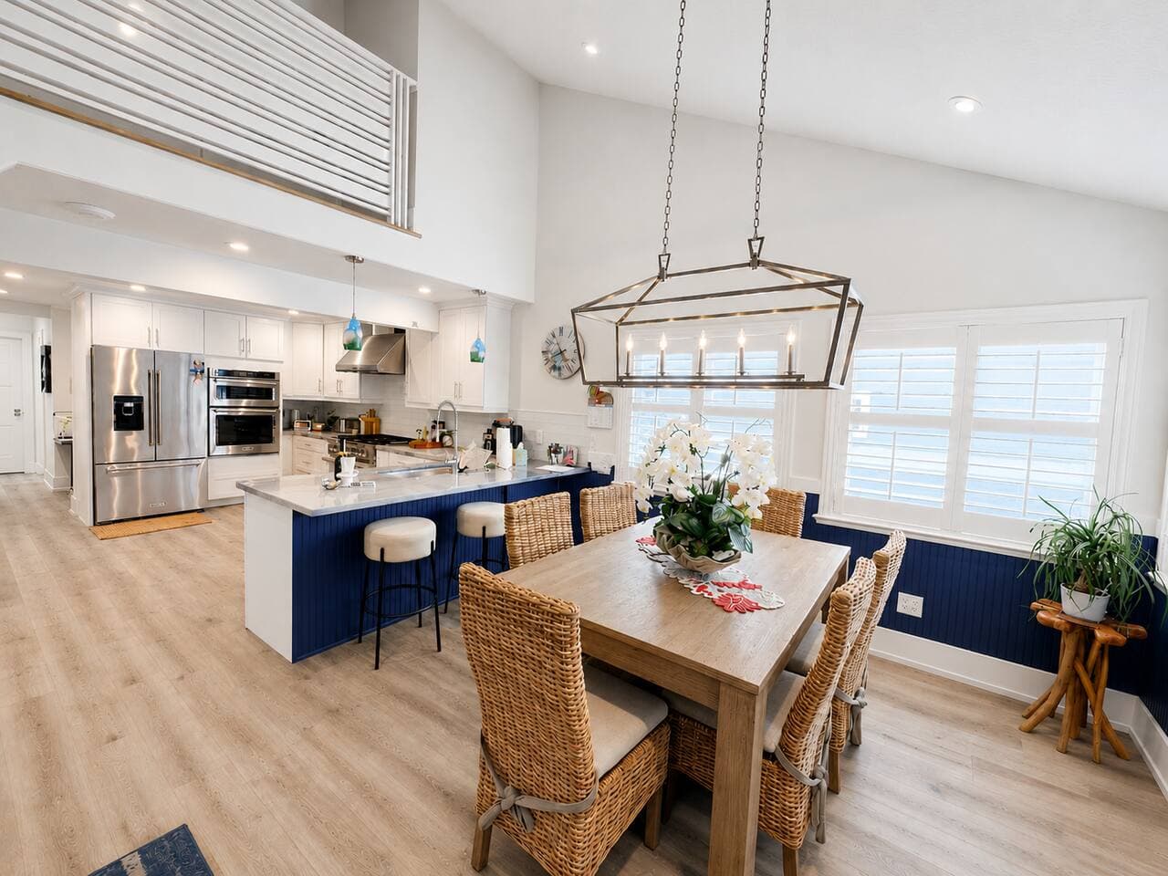 Bright open kitchen and dining space with island seating and vaulted ceilings