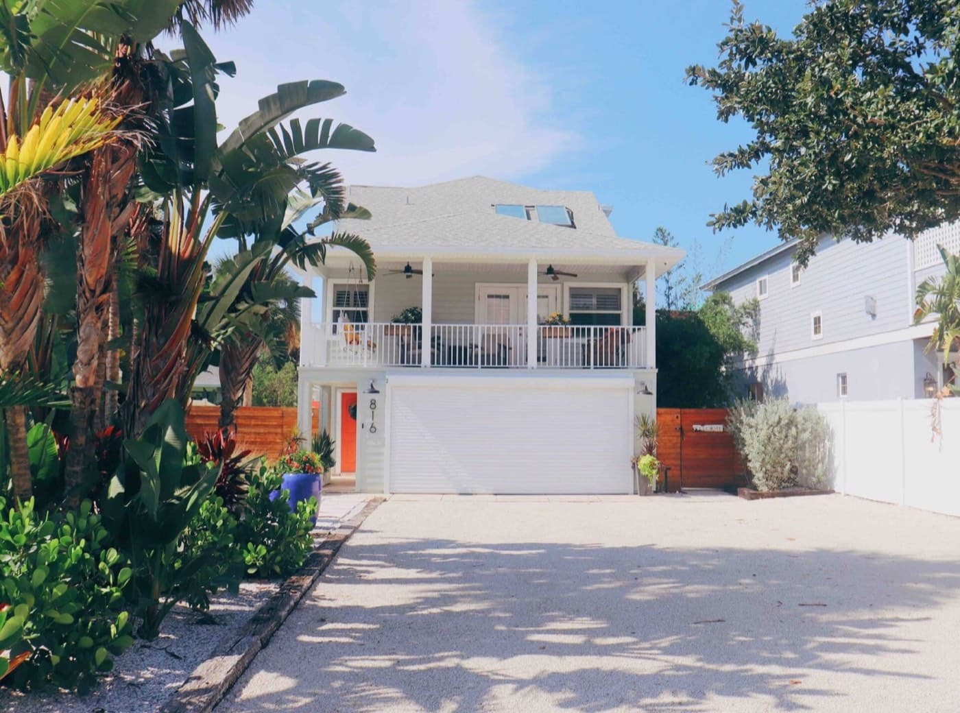 Charming coastal home with tropical landscaping and spacious balcony