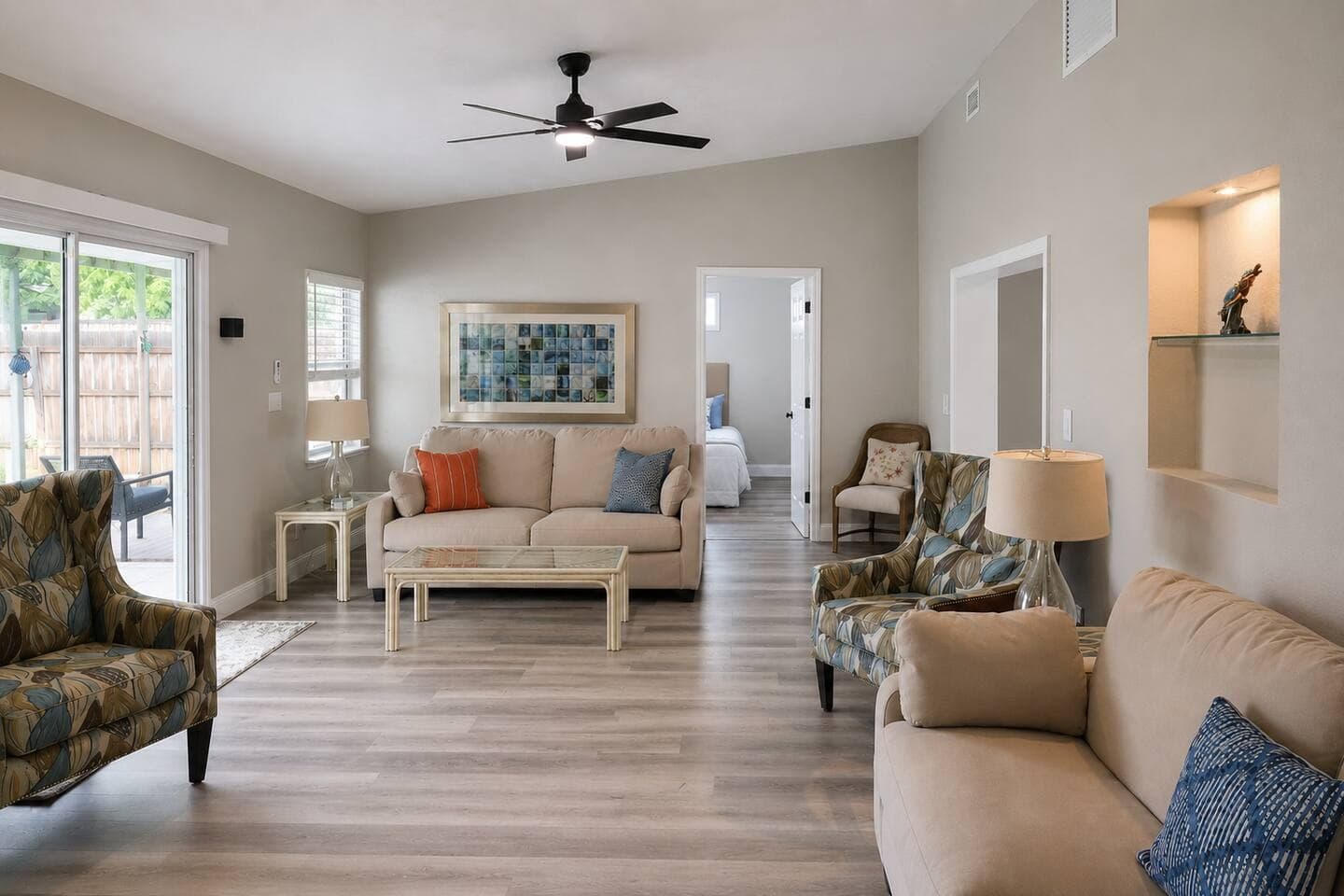 Bright open living room with vaulted ceilings and easy outdoor access
